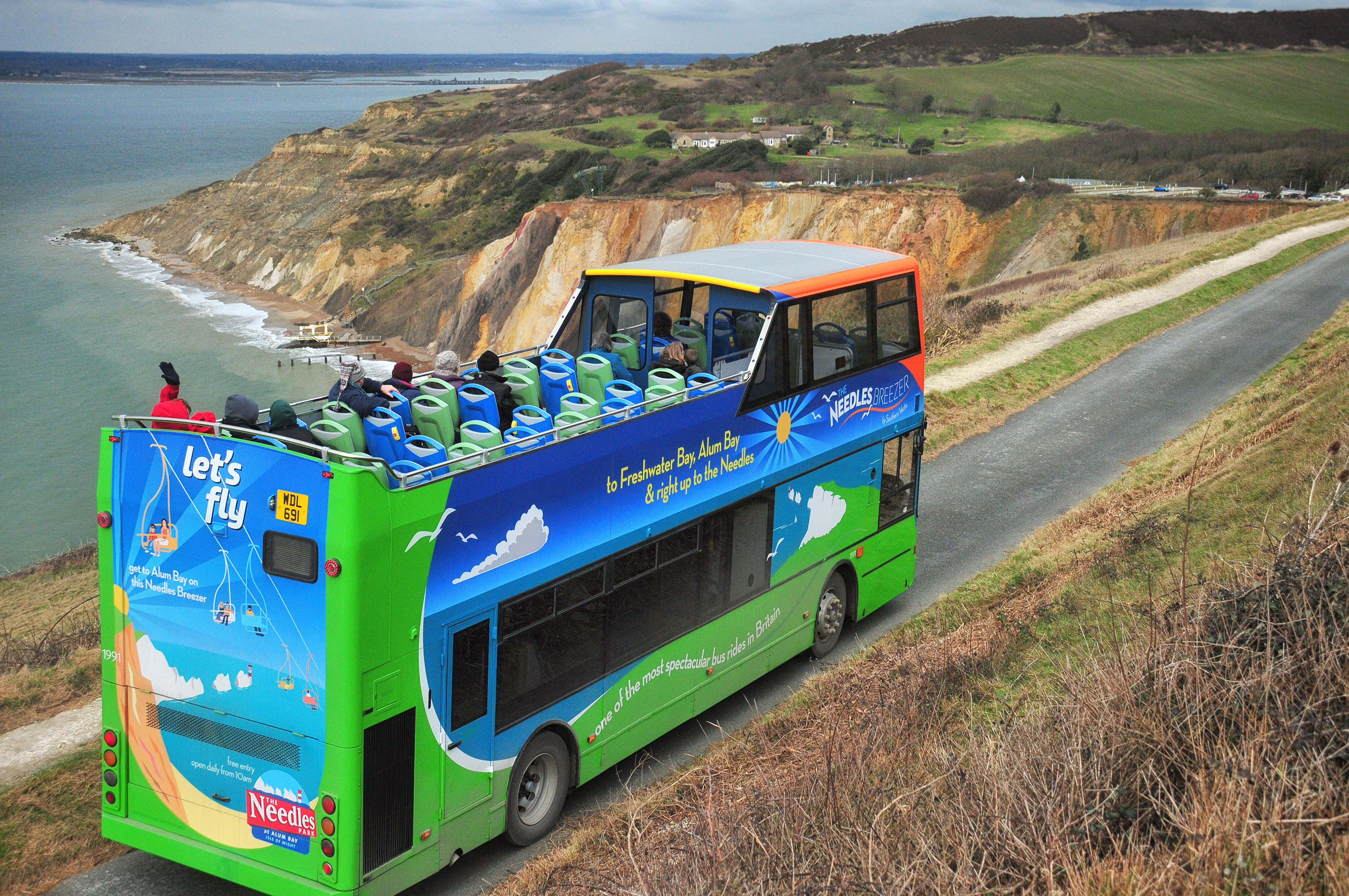 open top bus on coastal road